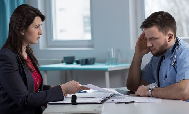 Insurance lawyer asking chiropractor questions in deposition