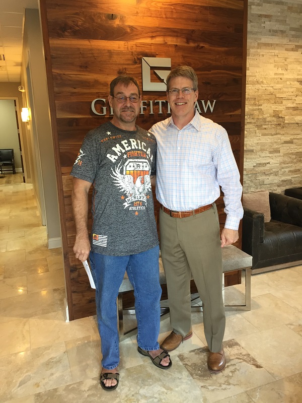 John with Cliff who suffered neck injuries from a head on collision