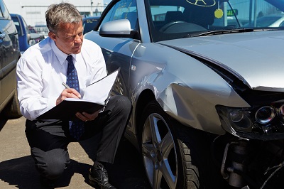 Insurance adjuster determining at fault driver in car accident