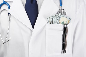 Doctor with money stuffed in shirt pocket