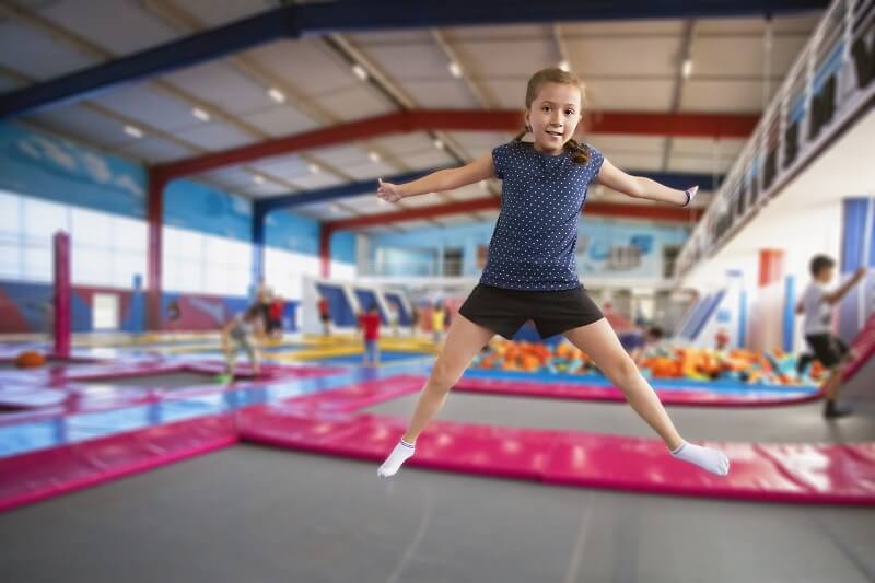 Young girl jumping on trampoline at Jump Zone theme park in Tennessee
