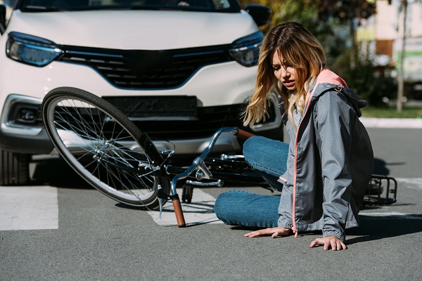 Picture of injured bicyclist in street after being hit by car
