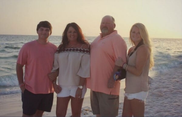 Lexie with her family on a beach
