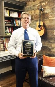 "John holding his TTLA Outstanding Trial Lawyers Award"