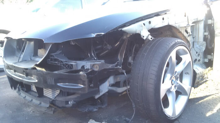 Wrecked BMW with damaged and missing body panels