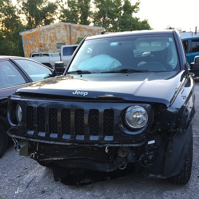 Wrecked Jeep Cherokee from accident involving driver running red light