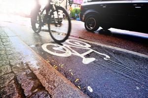 bicycle in bike lane next to car rainy day
