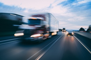 blurred image of a semi truck on an interstate
