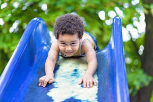 child coming down a slide head first