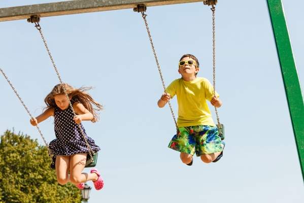 children swinging on playground