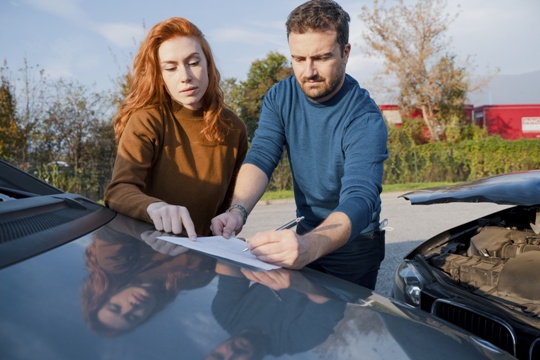 couple exchanging information after a car accident