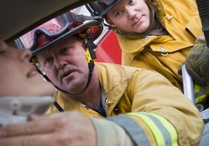 Firefighters helping person hurt in accident