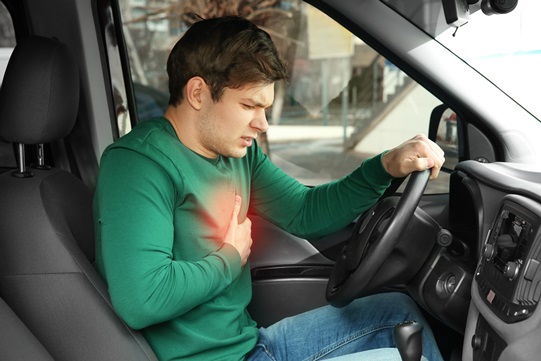 man having heart attack while driving a car