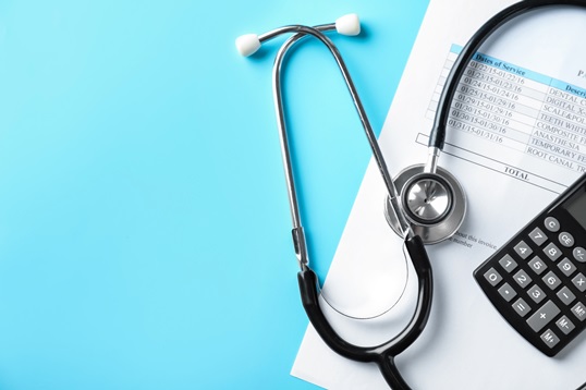 medical bill and calculator with stethoscope