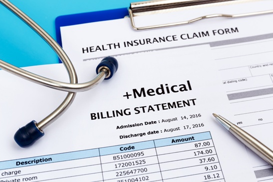 medical bills and stethoscope