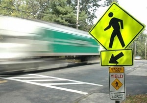 Pedestrian sign on a busy road