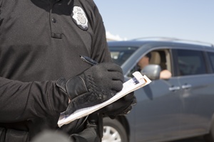 police officer writing a ticket for traffic violation