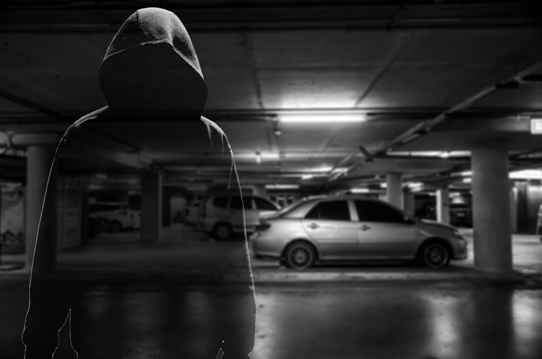suspicious looking person in dark parking garage