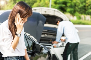 woman making cellphone call head on collision in background