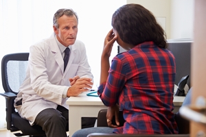 Doctor talking to patient at a desk