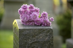 Headstone with flowers on it