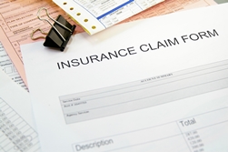 Insurance Claim Form Surrounded by Medical Bills