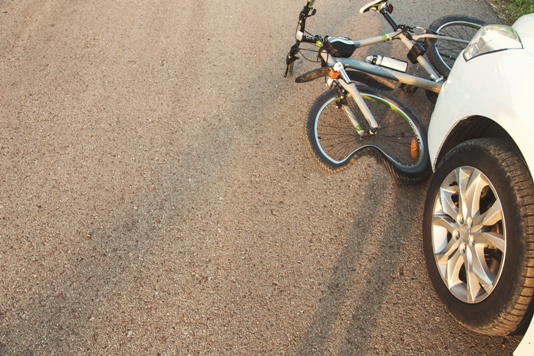 car running over bicycle
