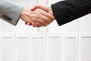 two people in suits shaking hands