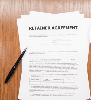 retainer agreement on desk with pen
