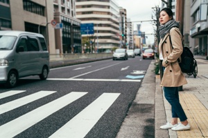 woman getting ready to cross street at crosswalk
