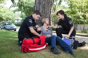 woman receiving emergency medical care after car accident