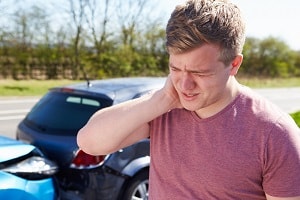 Man holding neck after rear-end collision