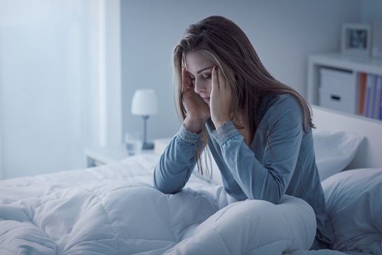 tired woman with a headache brain injury