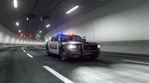 police-car-driving-through-highway-tunnel