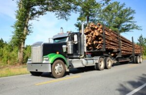 Semi-Truck hauling unbalanced logs